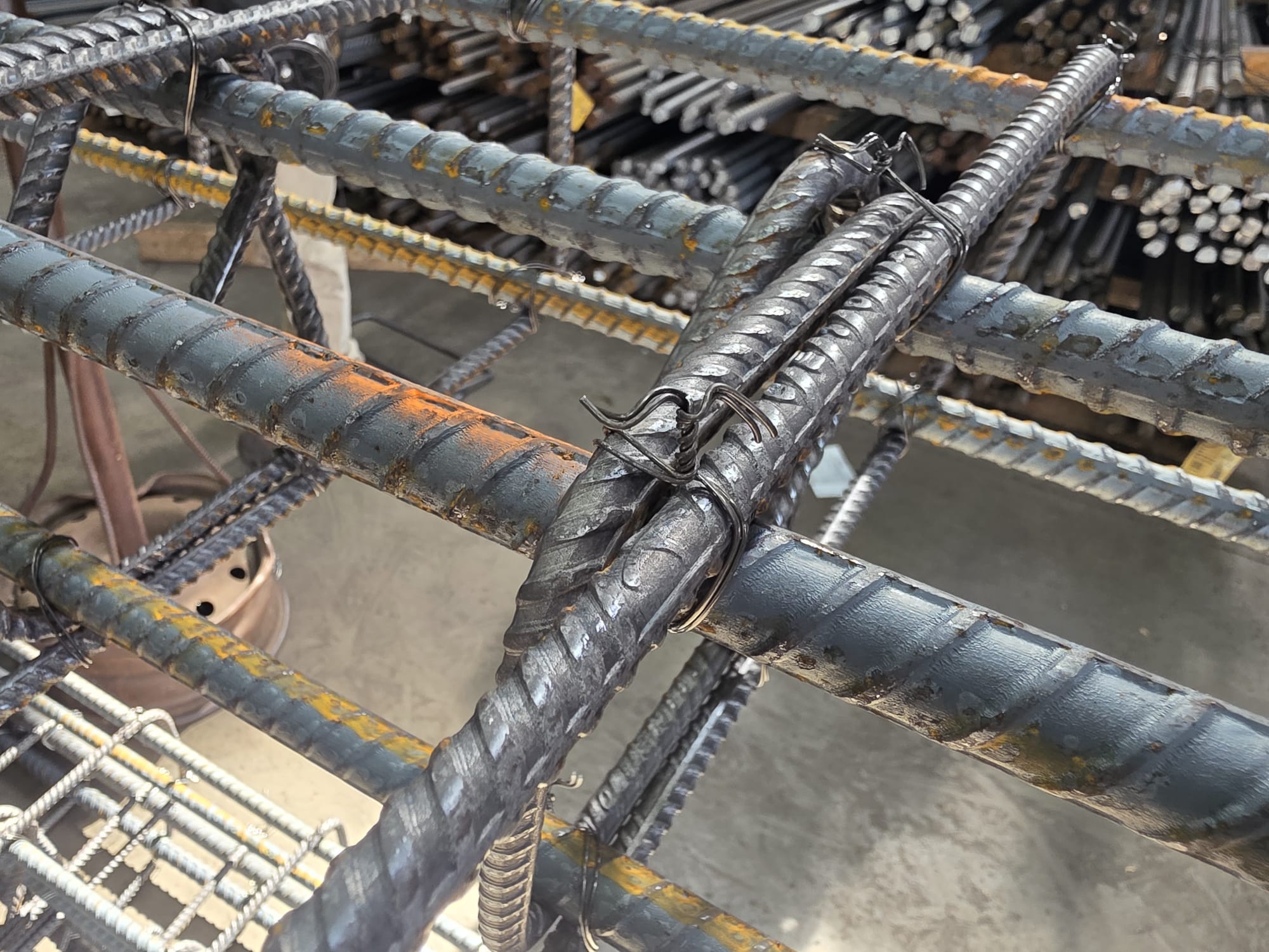 Rebar assembly with bars secured by twisted wire ties